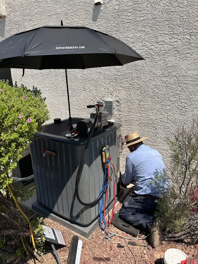 HVAC technician performing outdoor AC maintenance in Stayton